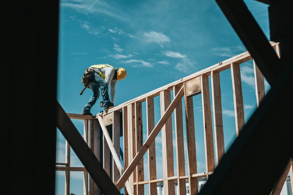 Builder working on a timber house frame