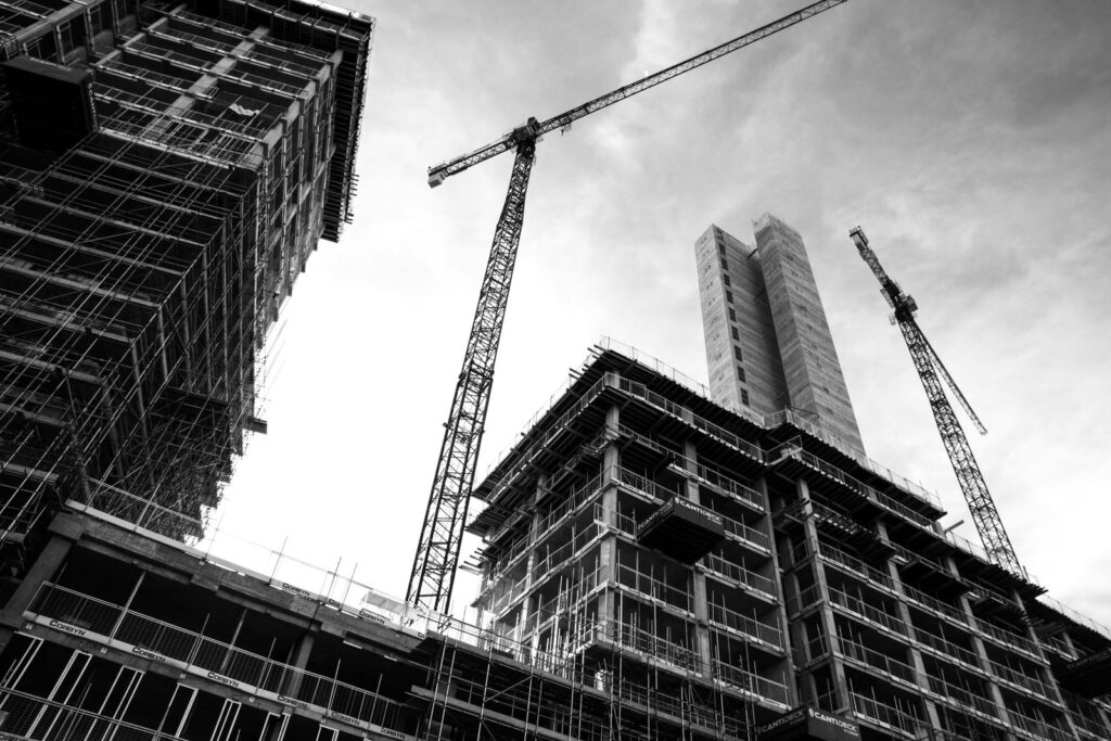 High-rise building under construction with tower cranes
