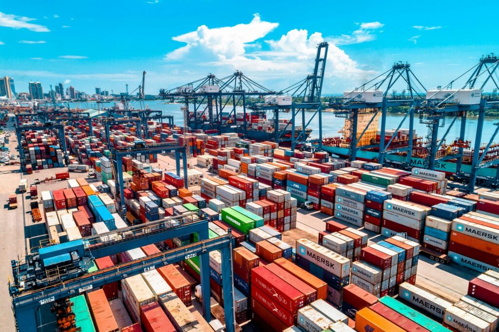 Shipping containers stacked at a busy port