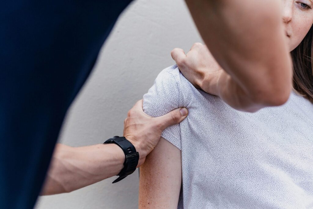 Physiotherapist assessing a patient's shoulder