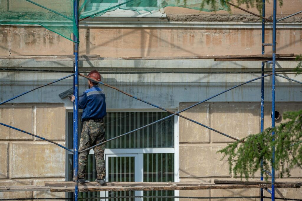Scaffolder working on a steel scaffold outside a building